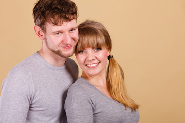 Young couple together hugging.