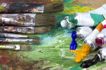 Paint colors and brushes on artist pallette