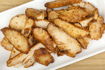 Slices of barbecued chicken on a platter