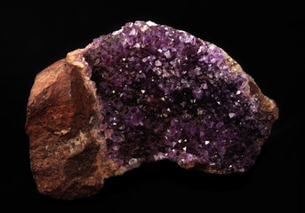 gemstone, druse of purple amethyst on black background, used toning og the photo 
