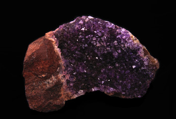 gemstone, druse of purple amethyst on black background, used toning og the photo 