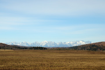 Obraz premium blue sky over the vast steppes, Tunka valley, mountains covered with snow, Sayan mountains. Used deep toning of the photo 