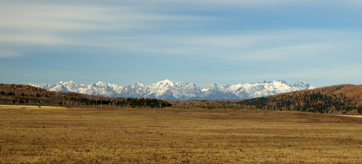 Obraz premium blue sky over the vast steppes, Tunka valley, mountains covered with snow, Sayan mountains. Used deep toning of the photo 