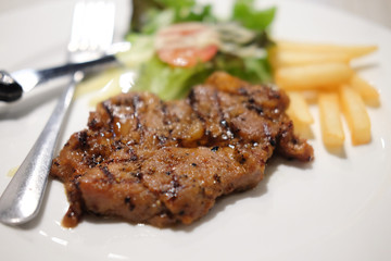 grilled steak, french fries and vegetables
