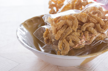 Crispy pig skin in the old bowl of Thai on table.Zoom in