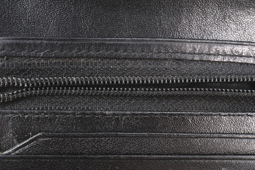 A zipper on old leather pouch