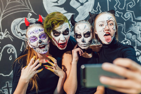 Three girls and a guy going on Halloween, grimace  make selfie