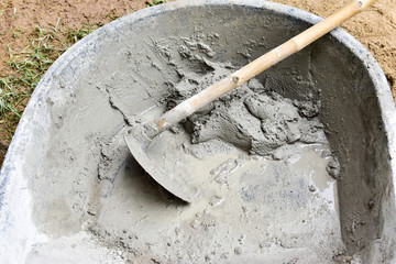Close up of Hoe place in cement mixers in mini construction work., spade, mattock