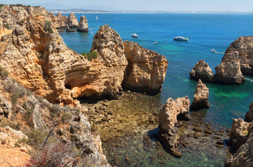 Idyllic beach landscapewith cliff and turquoise sea water on coast of Portugal in Algarve