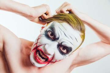 Naklejka premium Man with Halloween face art on white background