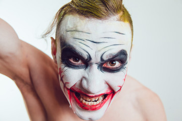 Man with Halloween face art on white background