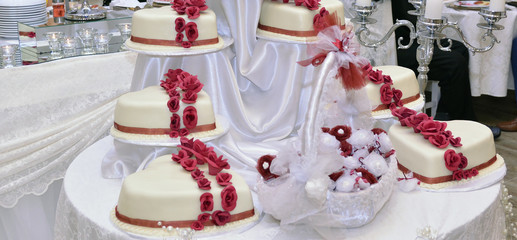 white Wedding Cake with red ribbons