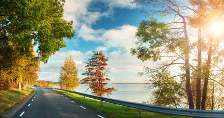 asphalt road at seaside at sunset in autumn