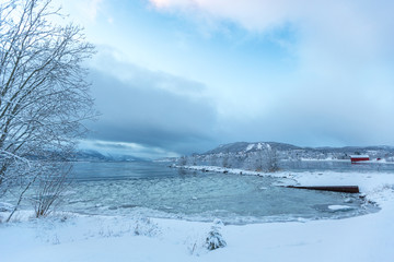 Fototapeta na wymiar Snow scene of village and lake