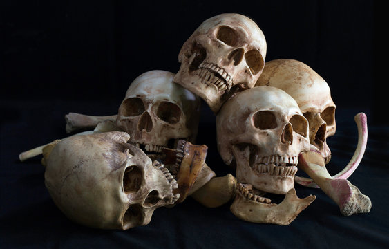 Awesome pile of skull and bone on black cloth background