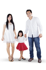 Fototapeta premium Cheerful Asian family holding hands