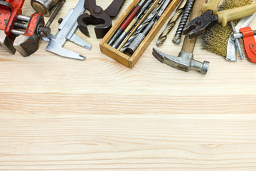 old tool set of various instruments for house repair and construction on wooden table background