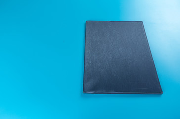 Empty business notebook cover on blue color background