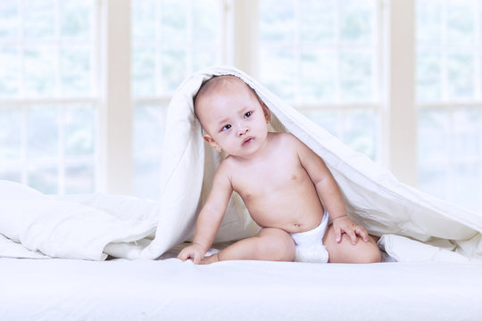 Cute baby inside blanket - indoor