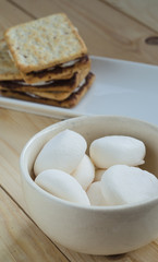 Fototapeta na wymiar Marshmallows in bowl and smores