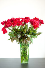Bunch of red roses in the glass vase