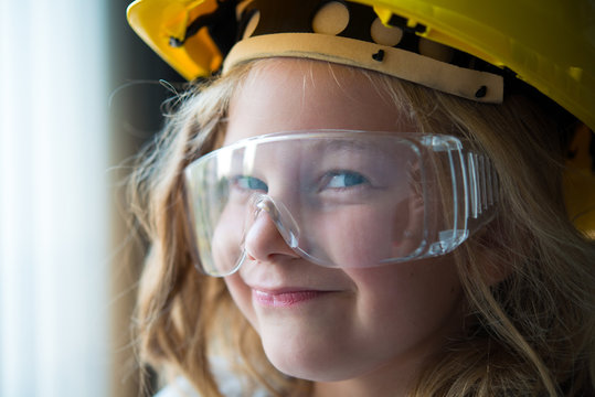 little girl with safety helmet and goggles