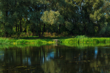 Fototapeta na wymiar River landscape with small wooden fishing pier