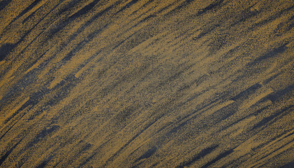 Blackboard with orange chalk scratches .