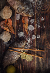 Food wooden background with Seafood, sticks, lime, salt. Copy sp