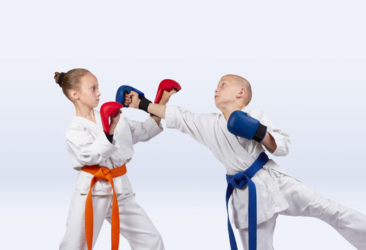 Girl and boy with the overlays on the hands are training strikes