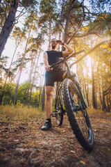 Plakat Cyclist Riding the Bike on a Trail in Summer Forest