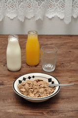 Breakfast with cereal, milk, orange juice
