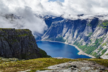 Naklejka na ściany i meble Norway traditional mountain landscape with fjord. Cloudy sky scene.