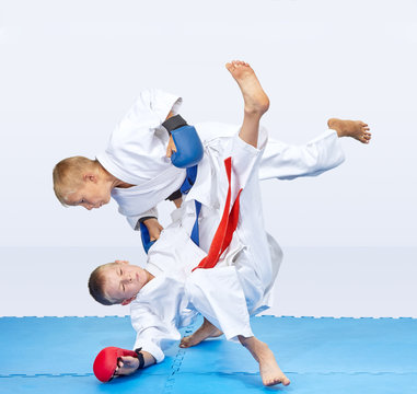 With a blue belt sportsman are throwing athlete with a red belt