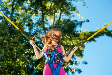 Girl jumping on a trampoline