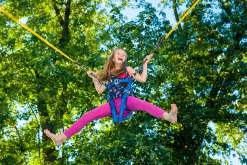 Girl jumping on a trampoline