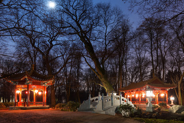 Traditional Chinese pavilions in Lazienki Park in Warsaw at nigh