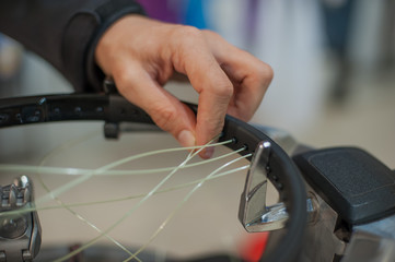 Stringing Machine. Close up of tennis stringer hands doing racket stringing in his workshop