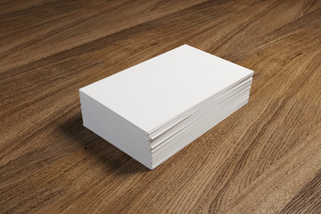 Fototapeta premium Stack of white business cards on the wooden table. 3d scene