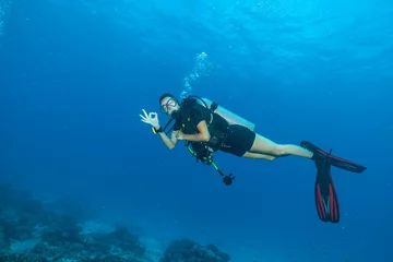 Fotobehang Young woman scuba diver showing ok sign © Jag_cz