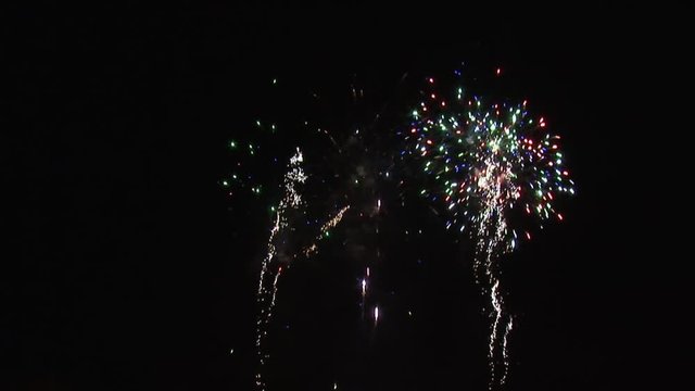 Red, Green and Blue Fireworks against Black Night Sky