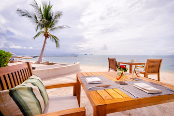 Table setting. Resort cafe on the tropical sea beach with beautiful view.