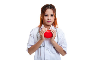 Asian young female doctor hold a red heart.