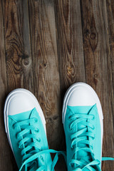sneakers on empty wooden surface