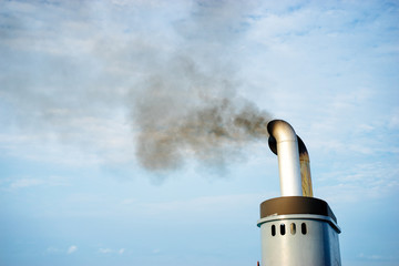 Sailing the sea. Ships chimney against blue sky.