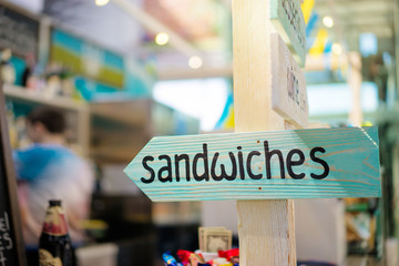 Pointing marker. Wooden sign arrow in cafe.