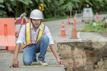 Engineer checking damaged road