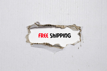 The word free shipping appearing behind torn paper