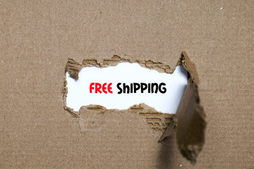 The word free shipping appearing behind torn paper