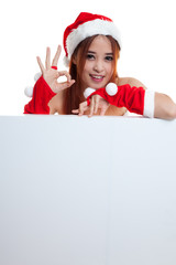 Asian Christmas Santa Claus girl show OK with blank sign.